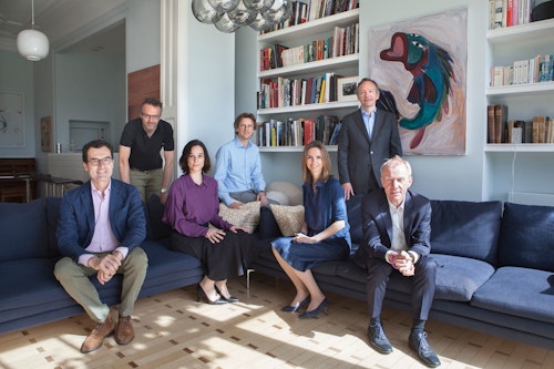 The team of Kickcancer sitting on sofas in their office