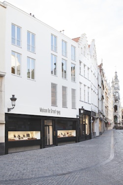 View of the street with the store of Maison De Greef by day