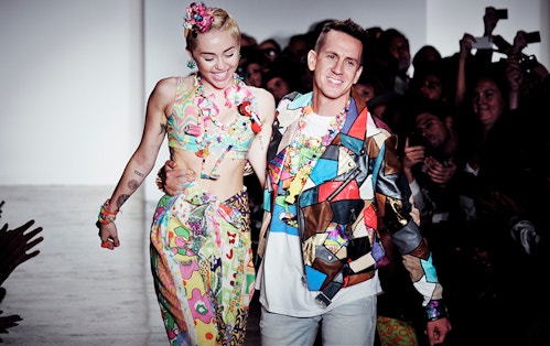 Miley Cyrus and Jeremy Scott walking side to side during the closing of the fashion show