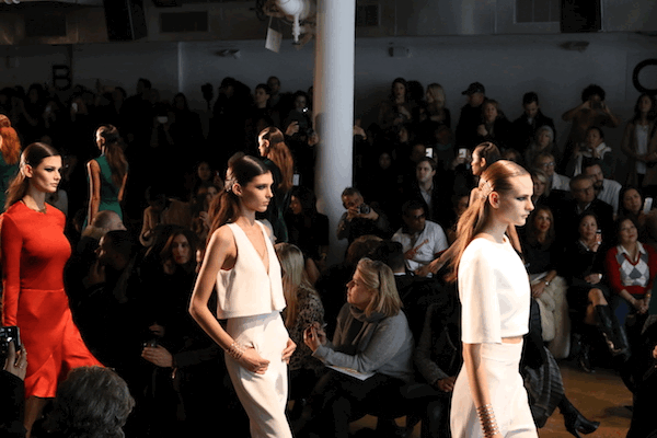 Models with black dresses during a fashion show