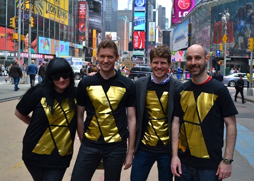 People in Times Square wearing a t-shirt designed with the NYC x Design logo