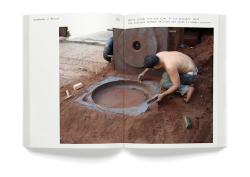 A opened book with the picture of a man working with soil
