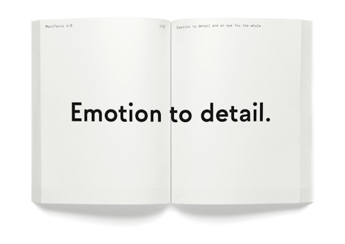 A opened book with the quote "Emotion to detail"